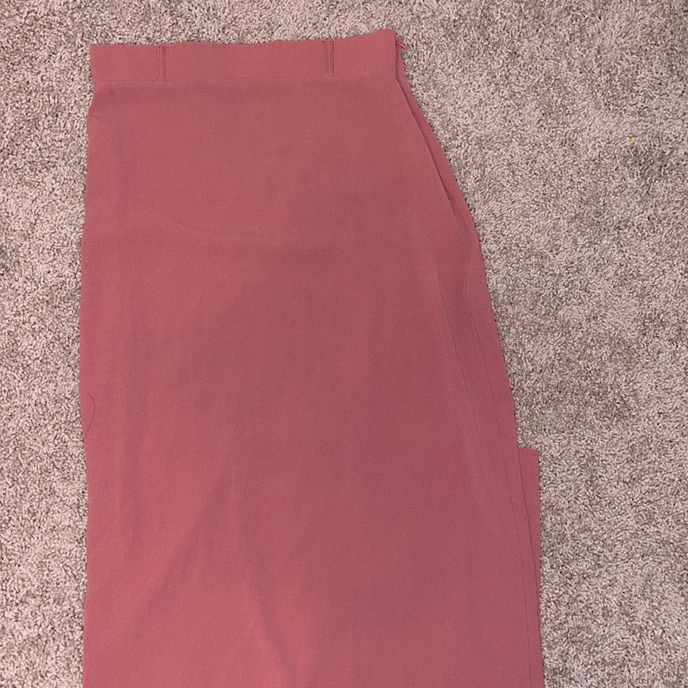 Long skirt, it hugs the body. With a slit.